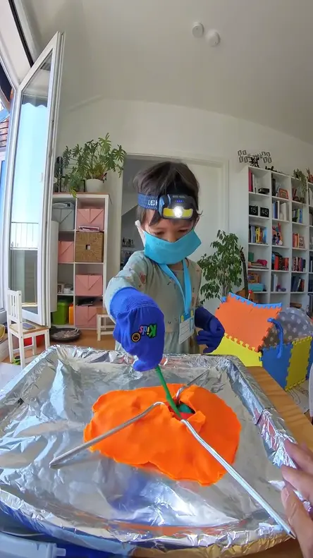 Plastic scalpel making an incision in the play-dough skin