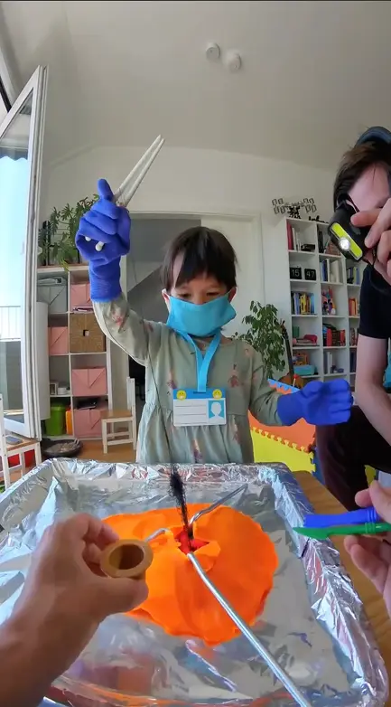 Tweezers removing a thread hairball from the play-dough stomach