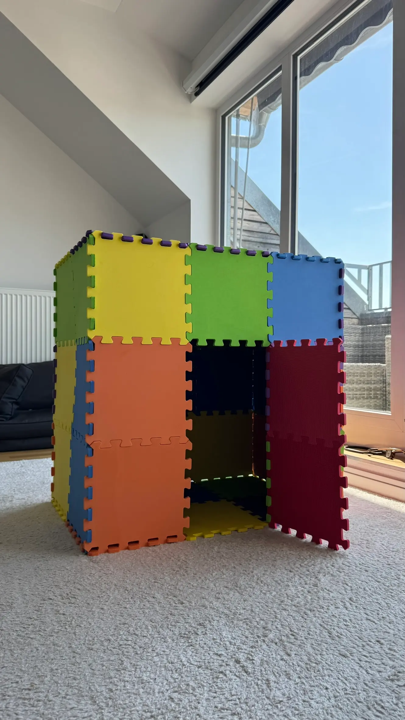 Secret Playhouse made of colorful puzzle mats with a swing-open door and privacy window